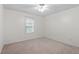 Neutral bedroom featuring a window, carpet flooring and a ceiling fan at 1851 Trailwood Heights Ln, Raleigh, NC 27603