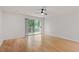 Bright bedroom with wood floors and sliding glass doors leading to a balcony at 1851 Trailwood Heights Ln, Raleigh, NC 27603