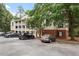 Exterior building view showcasing the brick facade, parking and mature trees providing shade at 1851 Trailwood Heights Ln, Raleigh, NC 27603