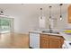 Bright open-concept living area featuring a well-equipped kitchen with modern appliances and a balcony at 1851 Trailwood Heights Ln, Raleigh, NC 27603