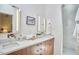 Bright bathroom featuring double vanity, modern mirrors, and a glass-enclosed shower at 19 Learned Pl, Durham, NC 27705