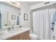 Well-lit bathroom featuring a vanity with marble countertop, and tub-shower combo at 19 Learned Pl, Durham, NC 27705