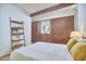 Sunlit bedroom showcasing wood storage cabinets, a leaning bookshelf, and a comfortable bed at 19 Learned Pl, Durham, NC 27705