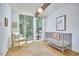 Bright bedroom with a large window view, complemented by a modern crib and minimalist decor at 19 Learned Pl, Durham, NC 27705