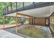 Carport under the deck with metal support beams and brick details at 19 Learned Pl, Durham, NC 27705