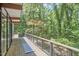 View of the deck featuring wood flooring and metal railings, surrounded by lush greenery at 19 Learned Pl, Durham, NC 27705