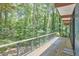 Large deck with modern railings offers a view of the wooded backyard at 19 Learned Pl, Durham, NC 27705