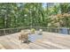 Elevated deck with contemporary seating surrounded by a verdant, mature landscape at 19 Learned Pl, Durham, NC 27705
