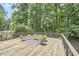 Outdoor deck with modern furniture and wood railing overlooking a lush, green landscape at 19 Learned Pl, Durham, NC 27705