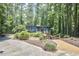Driveway and landscaped front yard with flowers and gravel path leading to this home with blue siding at 19 Learned Pl, Durham, NC 27705
