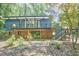 View of the home's exterior featuring a deck and lower level brick details at 19 Learned Pl, Durham, NC 27705