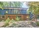 The back exterior of home with a deck above a brick lower level at 19 Learned Pl, Durham, NC 27705
