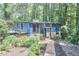Beautiful two-story home with blue siding, brick accents and large windows in a serene wooded setting at 19 Learned Pl, Durham, NC 27705