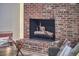 Detailed view of a brick fireplace with firewood, adding warmth and character at 19 Learned Pl, Durham, NC 27705