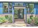 Close-up of the entryway with brick steps, a black front door, and views of the home's bright interior at 19 Learned Pl, Durham, NC 27705