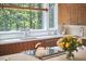 Bright, modern kitchen with wood cabinetry, stainless steel appliances, a large island, and a scenic view from the window at 19 Learned Pl, Durham, NC 27705