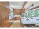 Modern kitchen featuring wood cabinetry, stainless steel appliances, a large island, and a skylight offering ample natural light at 19 Learned Pl, Durham, NC 27705