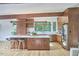 Spacious kitchen with wood cabinetry, a large island, stainless steel appliances, and a view of the wooded landscape at 19 Learned Pl, Durham, NC 27705