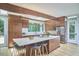 Well-lit kitchen featuring custom wood cabinets, a large island, stainless steel appliances, and windows with views of the outdoors at 19 Learned Pl, Durham, NC 27705