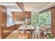 Open-concept kitchen featuring wood cabinets, a large island with seating, and views of the living area and outdoor scenery at 19 Learned Pl, Durham, NC 27705