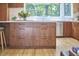 Modern kitchen island with walnut cabinets and a white countertop, brightened by a large window view at 19 Learned Pl, Durham, NC 27705
