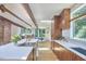 Bright kitchen with wood cabinets, stainless appliances, and a large island, complemented by a view into the dining area at 19 Learned Pl, Durham, NC 27705