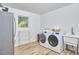 Laundry room featuring a washer, dryer, sink, and stainless steel refrigerator at 19 Learned Pl, Durham, NC 27705