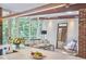 Bright living room featuring floor-to-ceiling windows, wood beam, and comfortable seating at 19 Learned Pl, Durham, NC 27705
