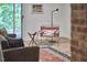 Charming living room showcasing modern seating, textured rug, and views of the outdoors at 19 Learned Pl, Durham, NC 27705