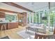 Open-concept living area showcases hardwood floors, wood beams, and large windows offering wooded views at 19 Learned Pl, Durham, NC 27705