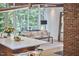 Cozy living room with floor-to-ceiling windows offering great outdoor views and brick wall at 19 Learned Pl, Durham, NC 27705