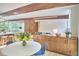 Open-concept living space, featuring kitchen island, dining area and exposed brick at 19 Learned Pl, Durham, NC 27705