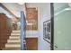 A staircase featuring modern lighting, and red brick wall, enhancing the homes unique interior design at 19 Learned Pl, Durham, NC 27705