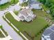 Aerial view of a home with a large, landscaped yard and patio at 200 Baskerville Ct, Holly Springs, NC 27540