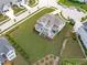 Expansive home with a well-manicured lawn, patio, and lush landscaping in a desirable neighborhood at 200 Baskerville Ct, Holly Springs, NC 27540