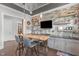Stylish bar area features stone backsplash, sleek cabinets, a built-in beverage cooler, and ample display shelving at 200 Baskerville Ct, Holly Springs, NC 27540