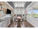 Custom bar area boasts stone accents, modern cabinets, wine storage, and a unique metallic-patterned ceiling at 200 Baskerville Ct, Holly Springs, NC 27540