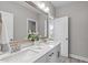 Bright bathroom with double vanity, quartz countertop and modern faucets at 200 Baskerville Ct, Holly Springs, NC 27540
