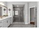 Modern bathroom featuring a gray tiled walk-in shower, sleek vanity, and neutral decor at 200 Baskerville Ct, Holly Springs, NC 27540