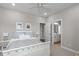 Bedroom with a white bedframe and views to the bath and hallway at 200 Baskerville Ct, Holly Springs, NC 27540