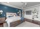 Comfortable bedroom with a blue accent wall, storage shelves, and stylish furniture at 200 Baskerville Ct, Holly Springs, NC 27540