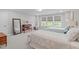 Spacious bedroom with two twin beds, neutral decor, and natural lighting from large windows at 200 Baskerville Ct, Holly Springs, NC 27540