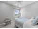 Cozy bedroom features a patterned bed, window with blinds, and a comfy decorative chair at 200 Baskerville Ct, Holly Springs, NC 27540