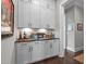 Charming butler's pantry featuring white cabinets, dark countertops, and decorative accents at 200 Baskerville Ct, Holly Springs, NC 27540