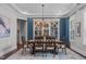 Elegant dining room featuring a large table, stylish chairs, and decorative lighting at 200 Baskerville Ct, Holly Springs, NC 27540