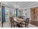 Spacious dining room with hardwood floors, stylish table and chairs, and modern lighting at 200 Baskerville Ct, Holly Springs, NC 27540