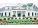 Elegant home with black-shuttered windows, a symmetrical design, and a well-kept garden at 200 Baskerville Ct, Holly Springs, NC 27540