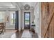 Bright foyer featuring hardwood floors, a decorative light fixture, and a view of the front door at 200 Baskerville Ct, Holly Springs, NC 27540
