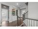 Hallway with staircase and decorative shelves for displaying photos and memorabilia at 200 Baskerville Ct, Holly Springs, NC 27540