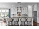 Kitchen showcases white cabinets, stylish pendant lighting, large island, and stainless-steel appliances at 200 Baskerville Ct, Holly Springs, NC 27540